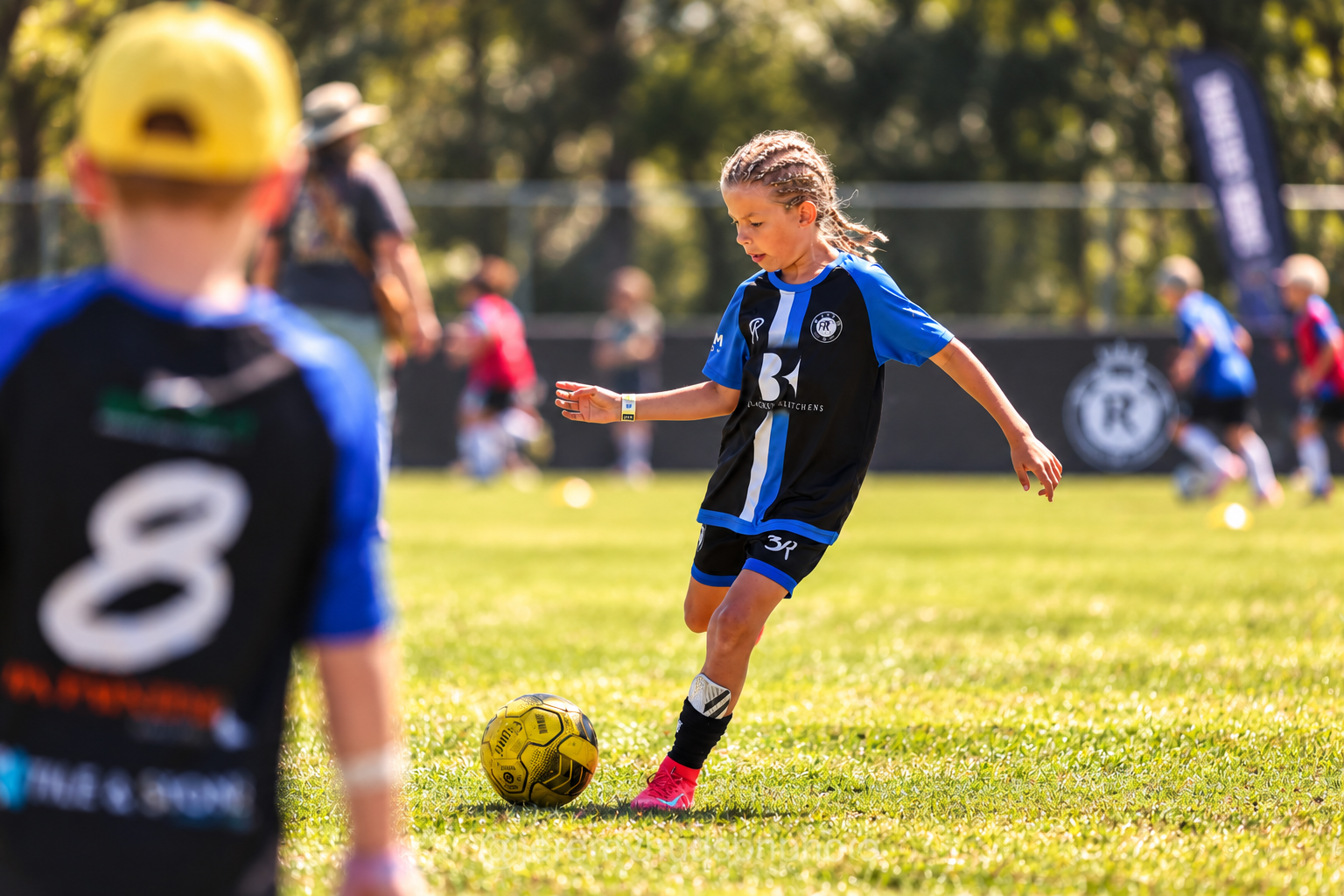 Young player controlling the ball under pressure